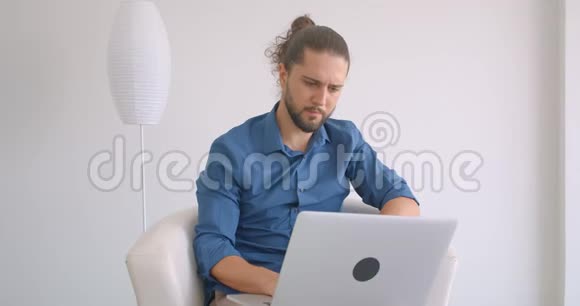 进步的自由职业者工作与笔记本电脑坐在扶手椅在舒适和轻的办公室视频的预览图