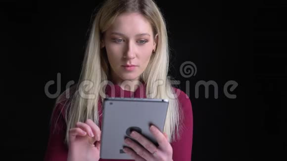 使用平板电脑拍摄的年轻漂亮白种人女性的特写照片在看镜头时她感到兴奋和惊讶视频的预览图