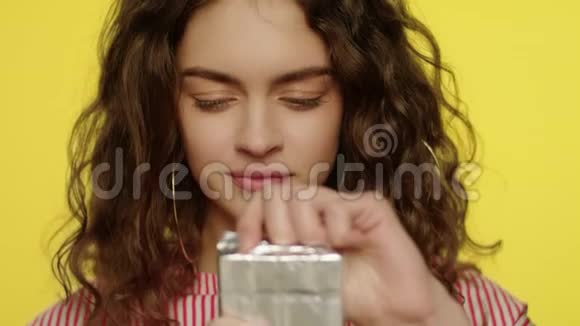 年轻女子打开巧克力棒快乐女孩吃巧克力的肖像视频的预览图