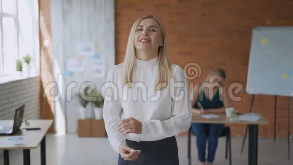 一个成功的女孩中镜头的肖像友好的女人微笑着看着镜头双臂交叉现代视频的预览图