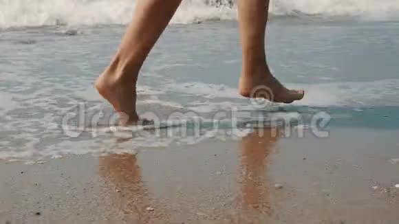 黄色动作女人脚在炎热的阳光沙滩上奔跑视频的预览图