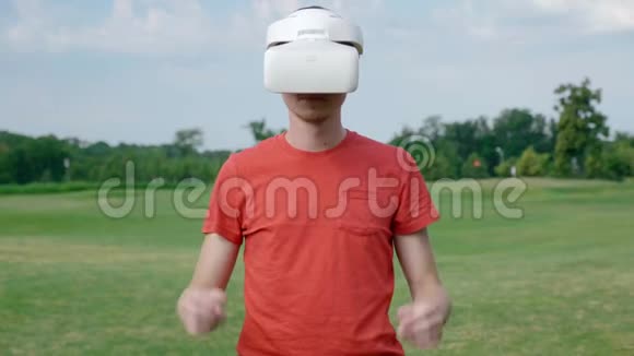 一个男人从公园的头上摘下他的VR耳机视频的预览图