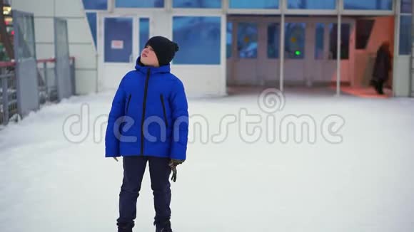 穿着蓝色羽绒服的少年在城里迷路了他在火车站环顾四周视频的预览图