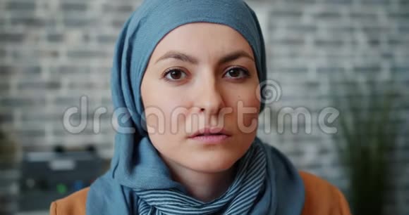 在办公室里看镜头的穆斯林女商人的特写肖像视频的预览图