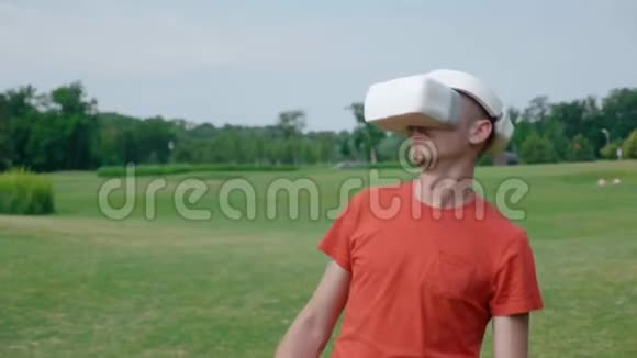 一个男人在公园里用VR耳机躲避障碍物视频的预览图