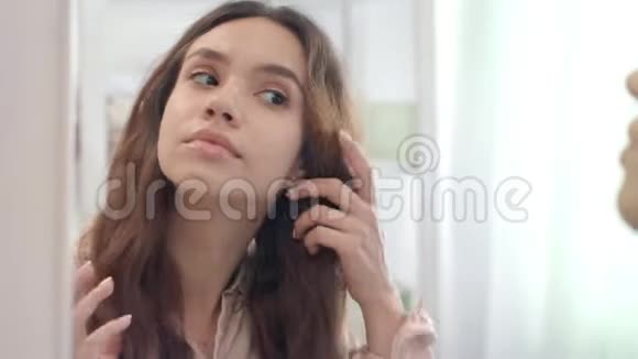 浴室里有个漂亮的女人用镊子夹着眉毛视频的预览图