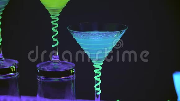 关闭鸡尾酒杯这是充满饮料和干冰在酒吧精彩的表演五颜六色的灯光引导慢慢视频的预览图