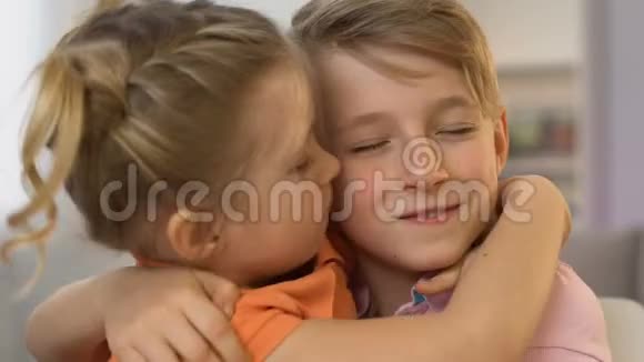 可爱的孩子拥抱女孩亲吻男孩的脸颊初恋快乐在一起视频的预览图