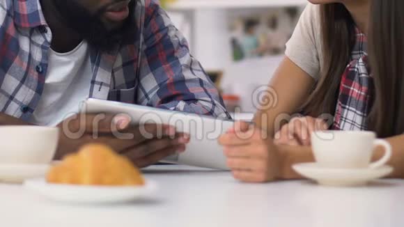 混合种族夫妇吃早餐用笔记本电脑支付账单轻松银行业务视频的预览图