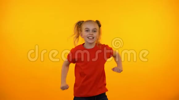 有趣的青春期女孩跳舞音乐活跃的孩子乐趣橙色背景视频的预览图