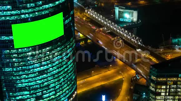 时间推移建筑和汽车夜间交通的空白绿色屏幕广告牌视频的预览图