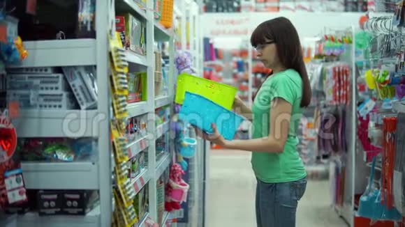 年轻女子在商店里选择小塑料篮子视频的预览图