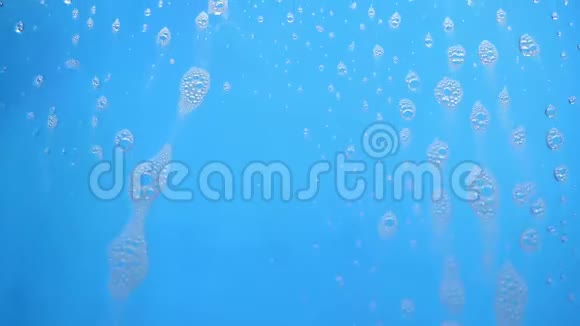泡沫泡沫泡沫从肥皂流动在蓝色背景视频的预览图