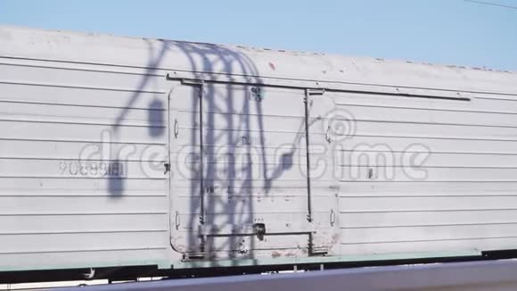 白色货车链在铁路上缓慢移动在晴天经过视频的预览图
