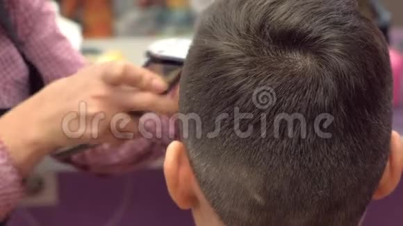 理发师在人的头上用剪刀剪头发后景造型师手特写视频的预览图