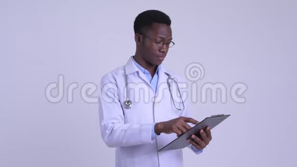 年轻快乐的非洲男子医生在剪贴板上看书竖起大拇指视频的预览图