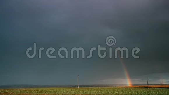 雨中的天空彩虹在地平线上的乡村景观场农业及天气预报概念视频的预览图