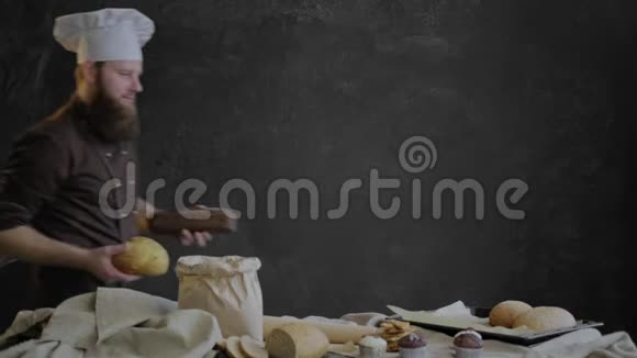 厨师把刚出炉的面包放在烤盘上用面包店的糕点装饰桌子视频的预览图