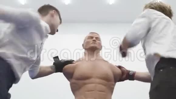 两个咄咄逼人的男人在健身房里打了一个筒子盒的人体模型视频的预览图
