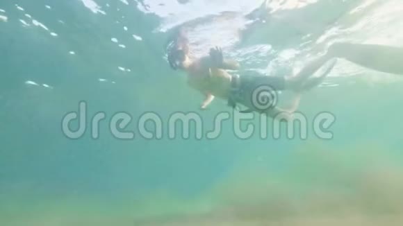 年轻人在浮潜面罩和管子里游泳拍摄自拍视频肖像男子浮潜在面具和浮潜下视频的预览图