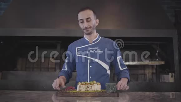 在现代火鸡餐厅附近厨师展示刚刚完成的美味菜肴的肖像穿着厨师制服的男人视频的预览图