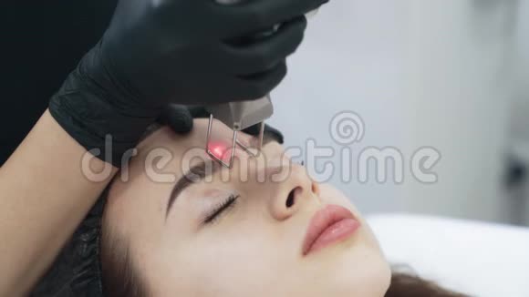 慢动作美容师用特殊设备做女孩面部脱皮视频的预览图