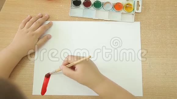 一个孩子右手拿着画笔在白纸上画一道彩虹视频的预览图