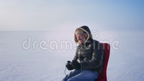 在冰冻的湖底比赛中获胜后身穿暖衣头罩的运动员们玩起了电子游戏举起了手视频的预览图
