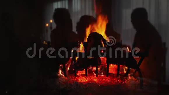 壁炉里燃烧着的木头和玻璃在那里你可以看到反射的影子视频的预览图