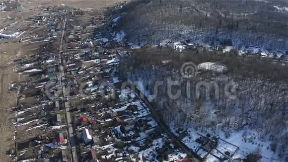 山脚下村舍的景色冬天航空测量视频的预览图