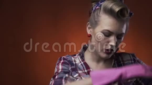 金发碧眼的女孩戴着粉红色的橡胶手套脸上带着微笑擦着额头上的汗水视频的预览图