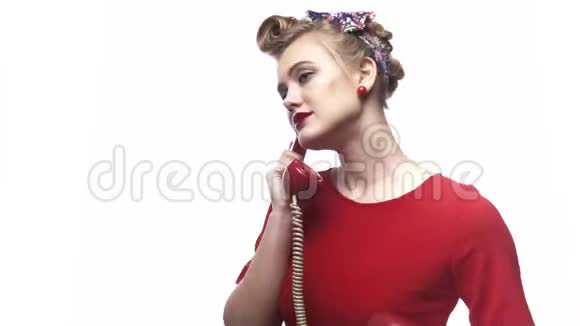 年轻漂亮的金发女郎穿着红色裙子正在打电话微笑着视频的预览图