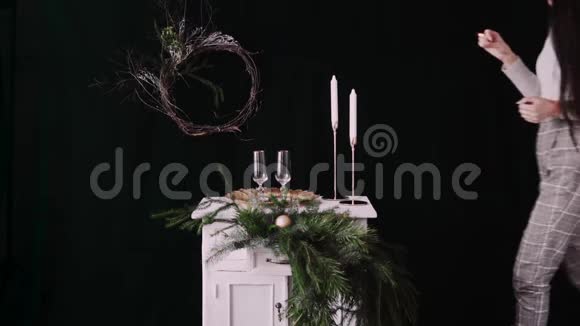 女人在圣诞餐桌上点蜡烛视频的预览图