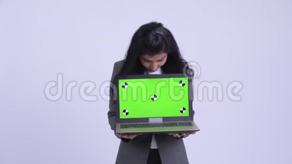 年轻快乐的波斯女商人展示笔记本电脑看上去很惊讶视频的预览图