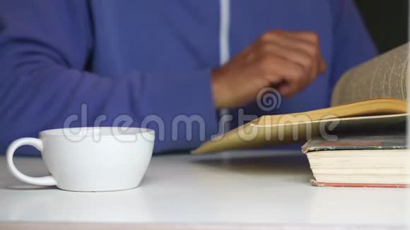 退休的人把书页翻翻在白色的桌子旁视频的预览图