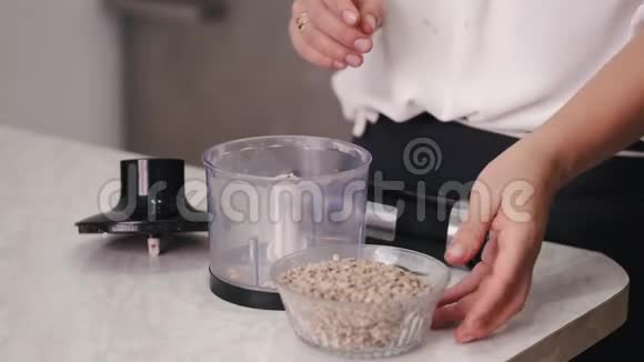 厨师正把种子倒进搅拌机里视频的预览图