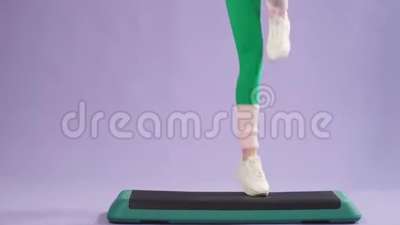 女健美操训练师展示如何在健身平台上做台阶动作视频的预览图