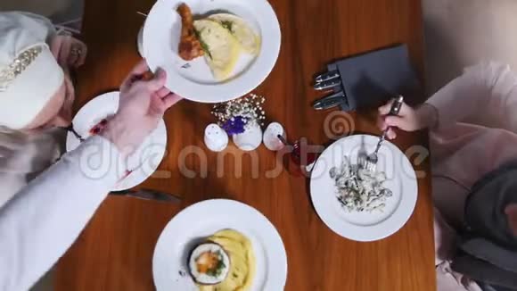 两个穆斯林妇女坐在餐馆吃沙拉服务员又端了一道菜视频的预览图