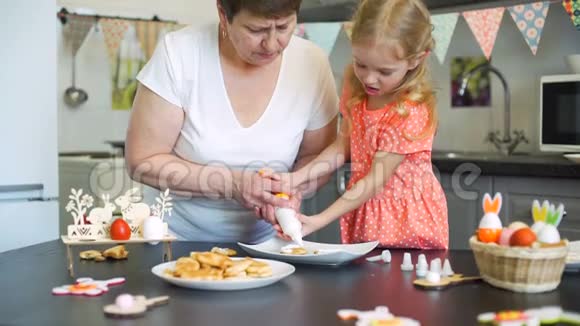 小女孩和奶奶一起在饼干里放奶油视频的预览图