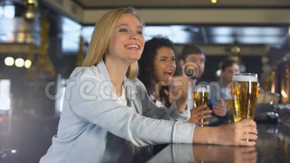 朋友们在酒吧里看体育节目举杯庆祝胜利视频的预览图