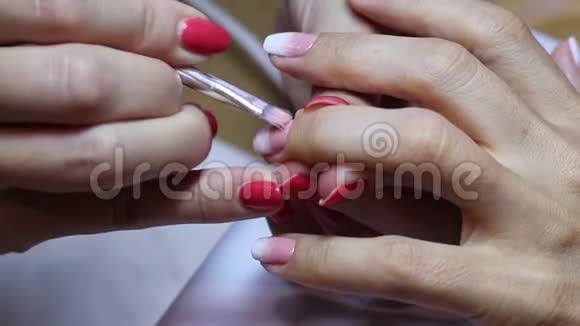 用刷子在女性指甲上创建一个梯度近距离观察手和手指漂亮的指甲艺术视频的预览图