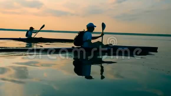 一群划手沿着湖边划独木舟视频的预览图