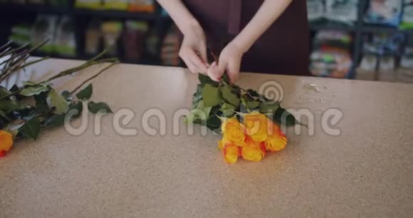 鲜花女售货员在商店里制作漂亮的玫瑰组合视频的预览图