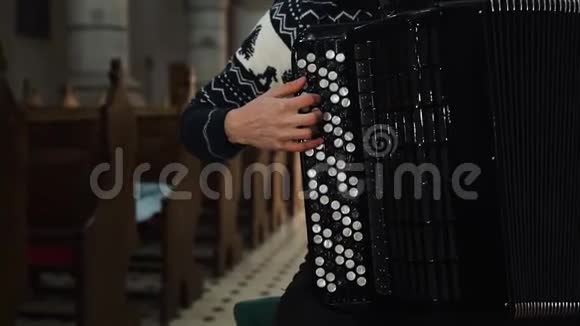 一位女音乐家正在旧教堂演奏手风琴关闭室内视频的预览图