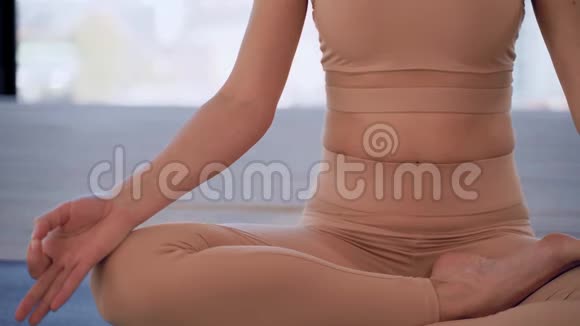 彩色瑜伽室内体育娱乐美丽的年轻女子手里拿着泥摆着冥想的姿势个人视频的预览图