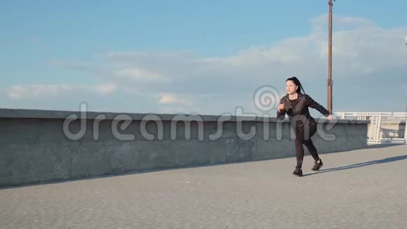 运动型的白种人女士清晨在海边跑步视频的预览图
