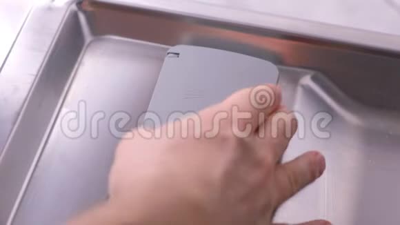 男人手在洗碗机的自动隔间里放洗涤剂片视频的预览图