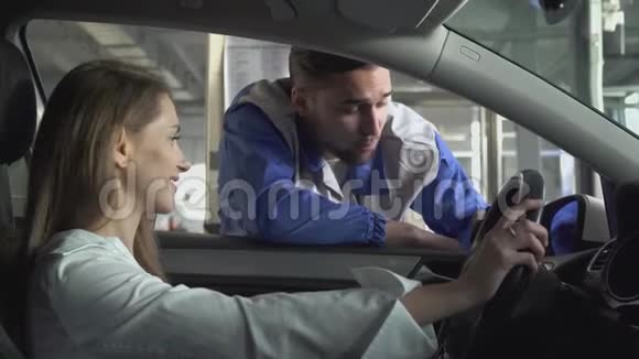 年轻女子坐在一辆漂亮的车里车窗上的自动驾驶机讲述了使用汽车的技术部分视频的预览图