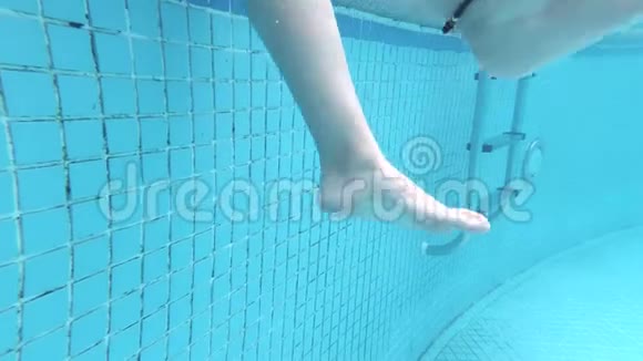水下看着温柔的女人用脚泼水炎炎夏日的喜悦游泳池和阳光慢慢视频的预览图