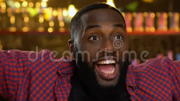 快乐的美国黑人体育迷在酒吧观看比赛庆祝球队胜利视频的预览图
